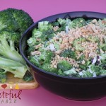 Broccoli Salad topped w/ peanuts, in black bowl